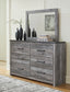 Bronyan King Panel Bed with Mirrored Dresser and Nightstand